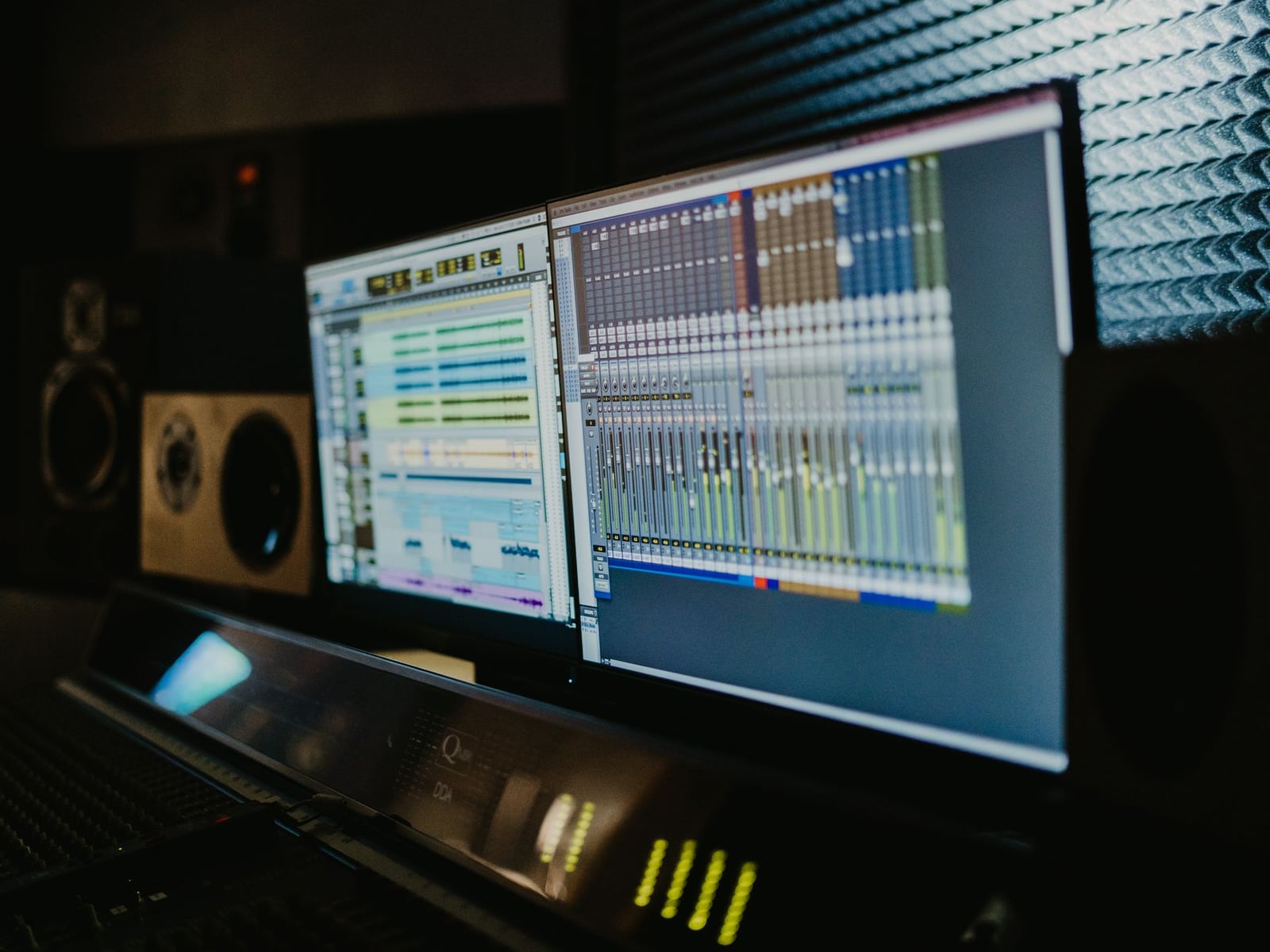 Music production software displaying a multi-track album project on a studio monitor