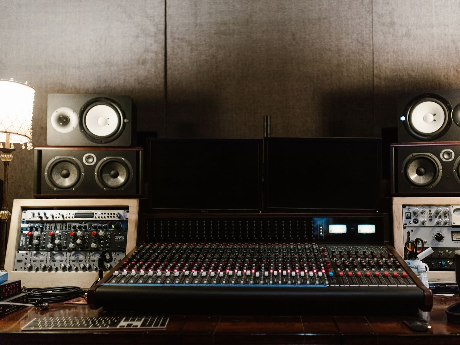 Professional analog mastering equipment with knobs and dials in a studio